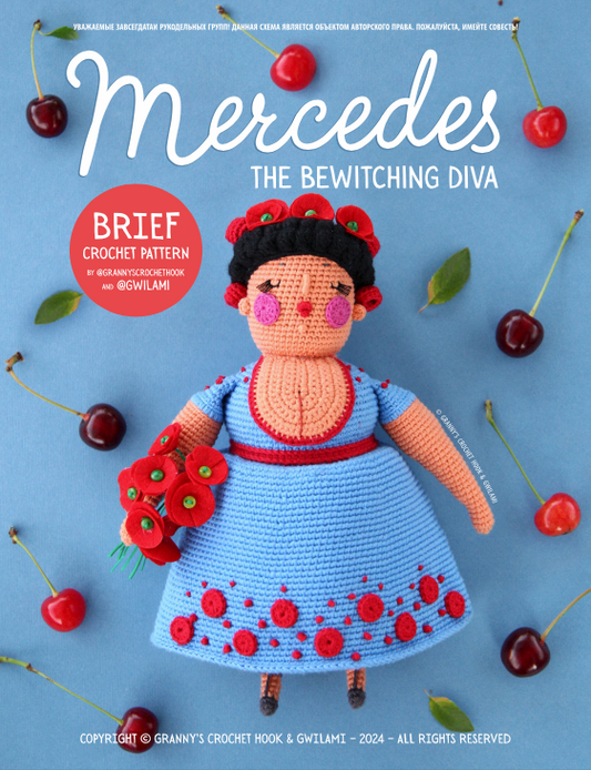 Cover of a crochet pattern book titled 'Mercedes the Bewitching Diva' featuring a crocheted doll with a blue dress, red beret, and holding a bunch of cherries, surrounded by cherries on a blue background.